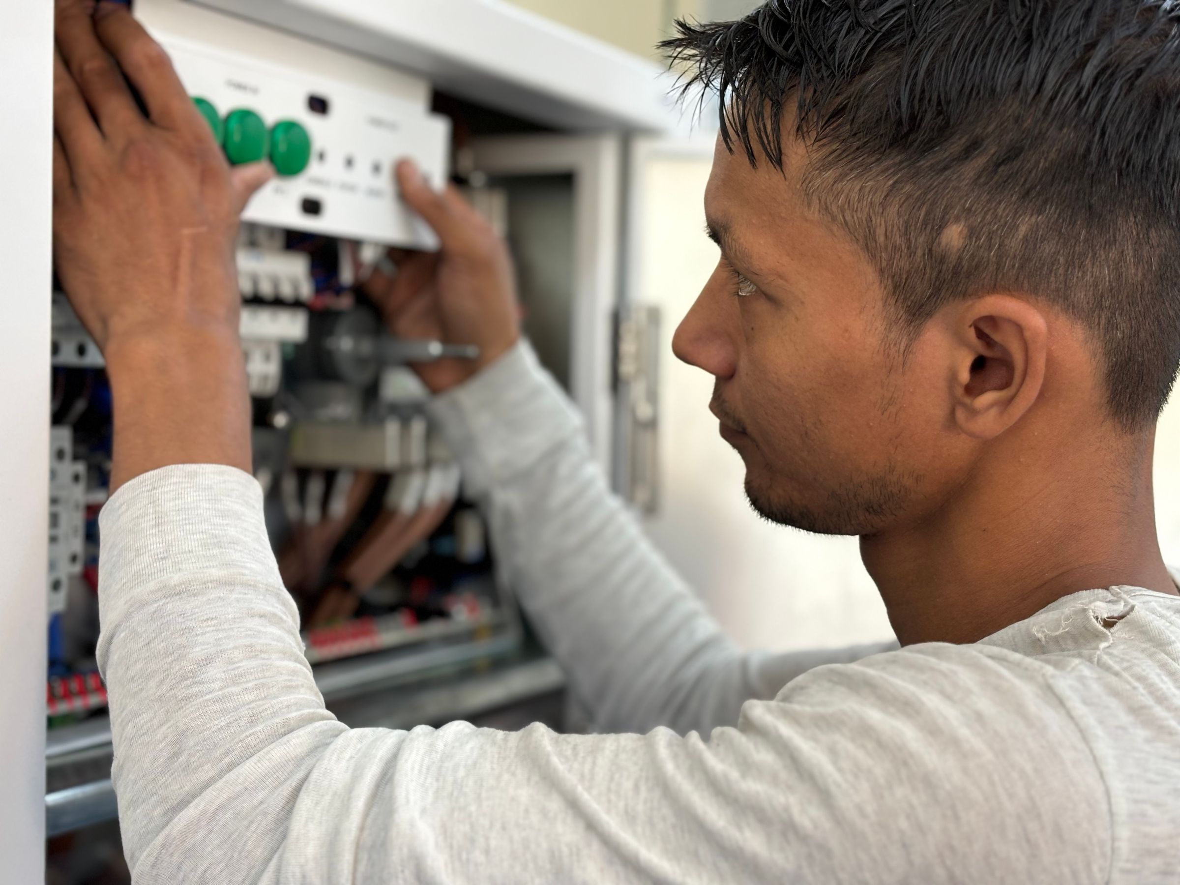 Electrician inspecting an electrical panel
