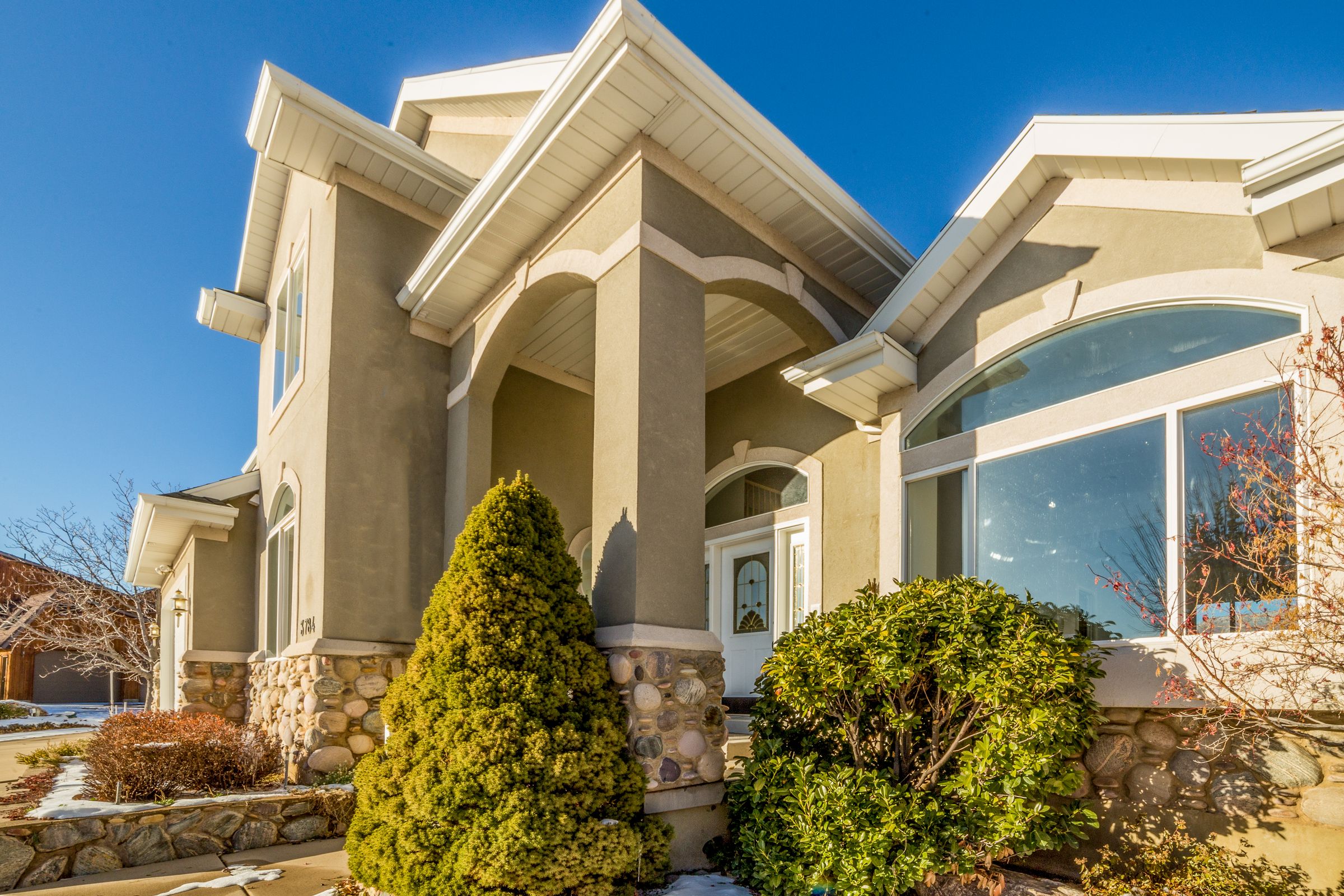 Residential home exterior with landscaped front entrance